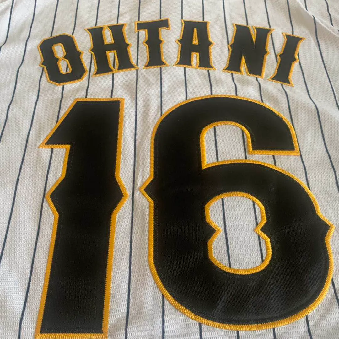 Back view of a white baseball jersey with black stripes, featuring the name "OHTANI" and the number "16" in bold lettering.