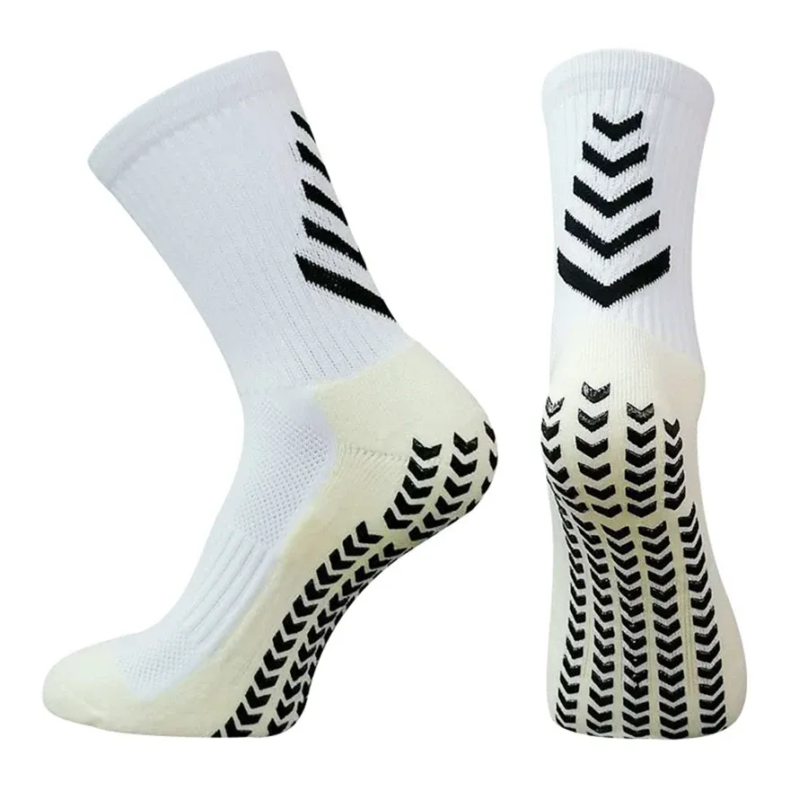 White athletic socks featuring black chevron patterns on the upper and textured grip soles for enhanced traction.