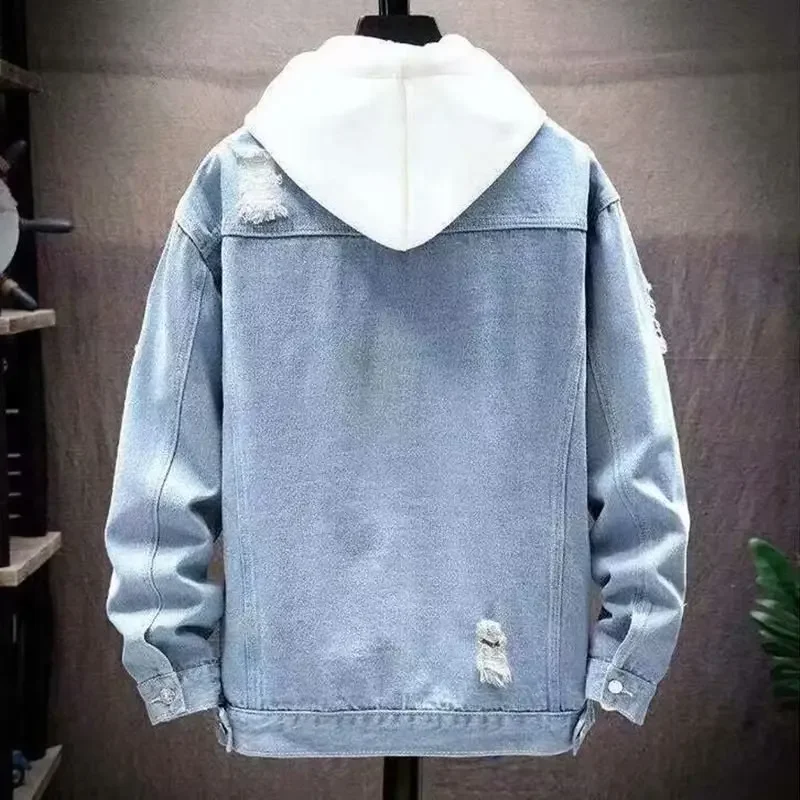 Back view of a light blue denim jacket with a white hood, featuring distressed details on the shoulders and lower hem.