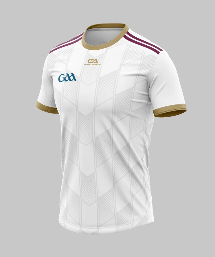 A Gaelic football jersey in white with gold and maroon accents, featuring a geometric design and GAA logo on the front.