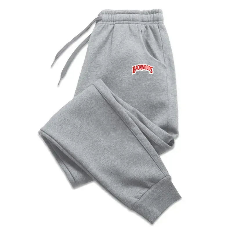 Gray sweatpants with a red "Backwoods" logo, featuring an elastic waistband and cuffs for a comfortable fit.