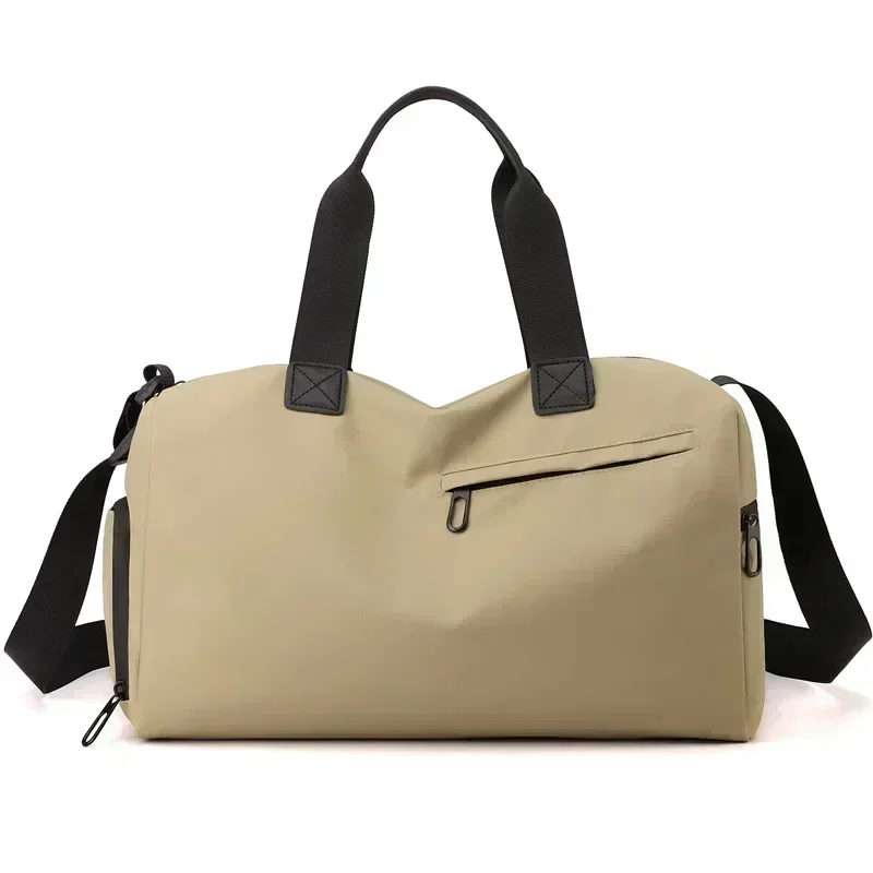 Beige duffel bag with black straps and a side zip pocket, designed for travel or gym use.